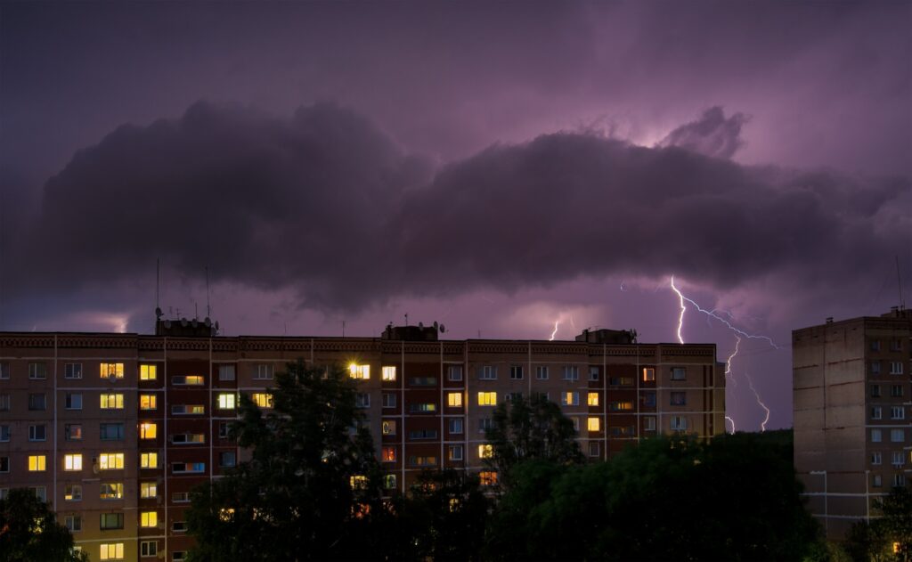 Thunderstorm lightning behind multi-family complex